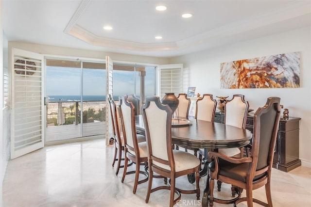 dining space with a tray ceiling, crown molding, and recessed lighting