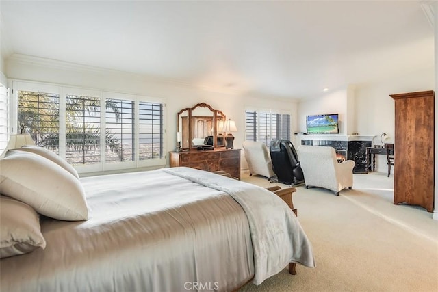 carpeted bedroom with ornamental molding and a premium fireplace