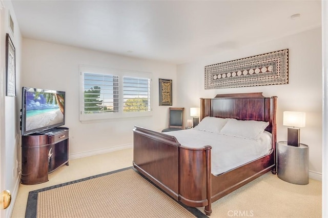 carpeted bedroom featuring baseboards