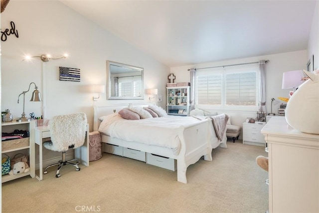 bedroom with vaulted ceiling, multiple windows, and light carpet