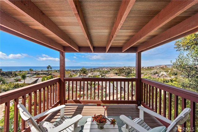 wooden terrace featuring a water view