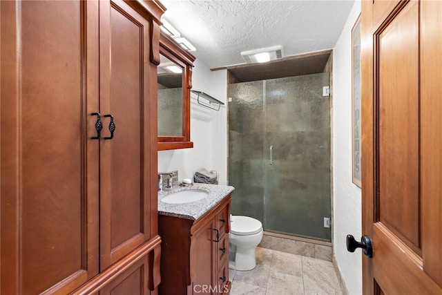 full bath featuring visible vents, a shower stall, toilet, vanity, and a textured ceiling