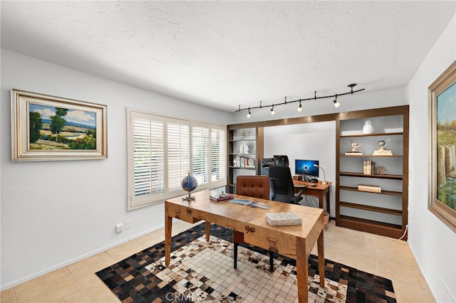 office area featuring light tile patterned floors, built in features, a textured ceiling, and baseboards