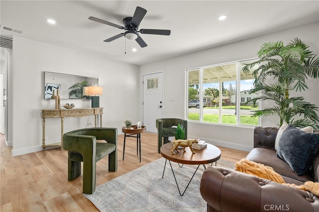 living room featuring recessed lighting, visible vents, and light wood finished floors