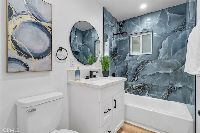 full bath featuring vanity, shower / bath combination, wood finished floors, and toilet