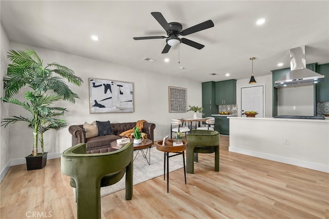 living area featuring light wood-style floors, recessed lighting, visible vents, and a ceiling fan