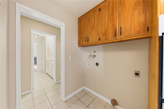 laundry area with light tile patterned flooring, hookup for a washing machine, baseboards, cabinet space, and electric dryer hookup