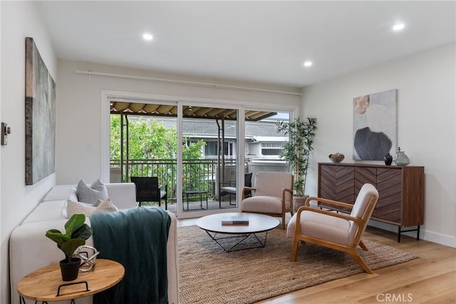 sitting room with recessed lighting, baseboards, and wood finished floors