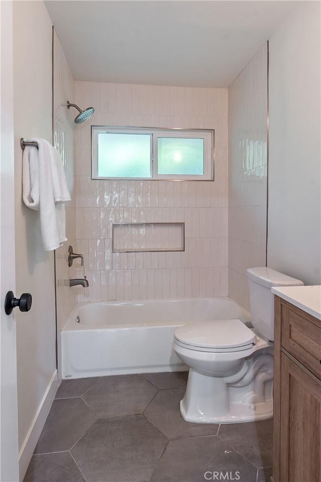 bathroom featuring washtub / shower combination, tile patterned flooring, plenty of natural light, and toilet