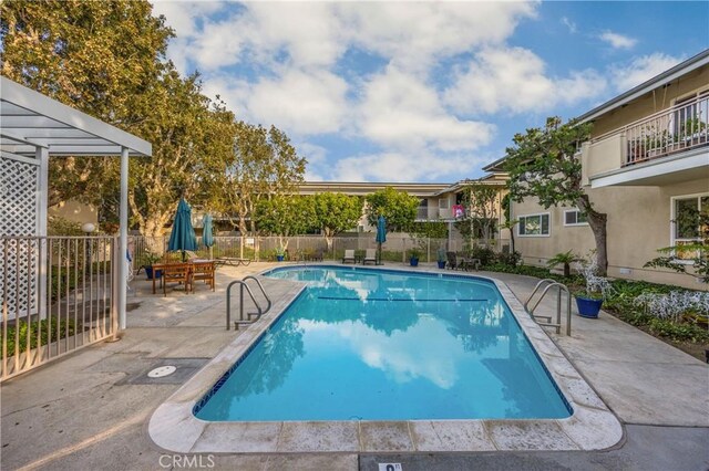 view of pool with a fenced in pool, a patio, and fence