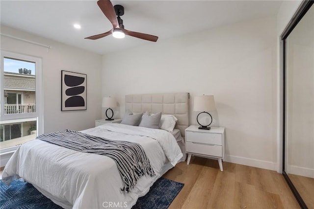 bedroom featuring ceiling fan, baseboards, and wood finished floors