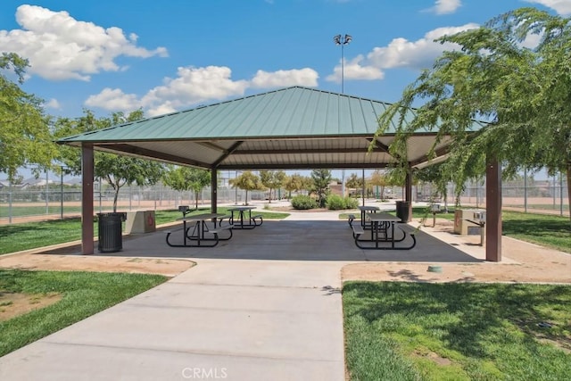 view of property's community featuring a gazebo, fence, and a lawn