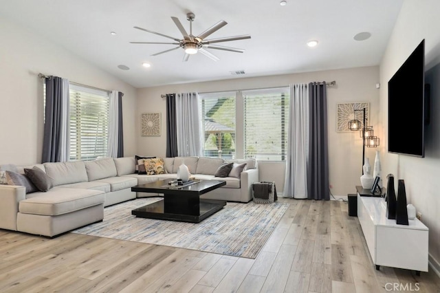 living area with recessed lighting, visible vents, vaulted ceiling, and light wood finished floors