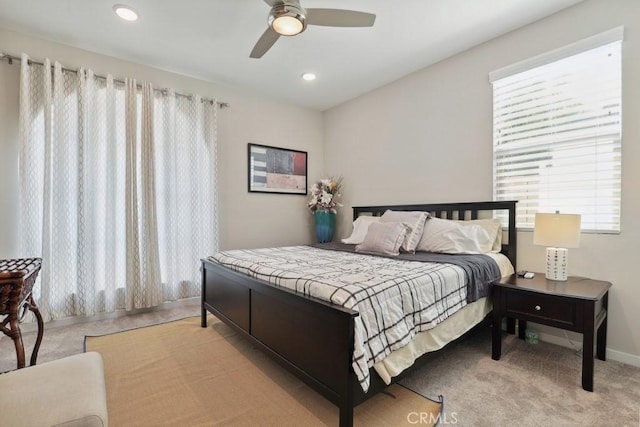 carpeted bedroom with recessed lighting, multiple windows, a ceiling fan, and baseboards