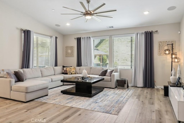 living room with visible vents, ceiling fan, light wood-type flooring, lofted ceiling, and recessed lighting