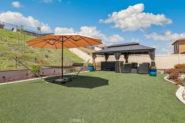 view of yard with a gazebo, outdoor lounge area, and a fenced backyard