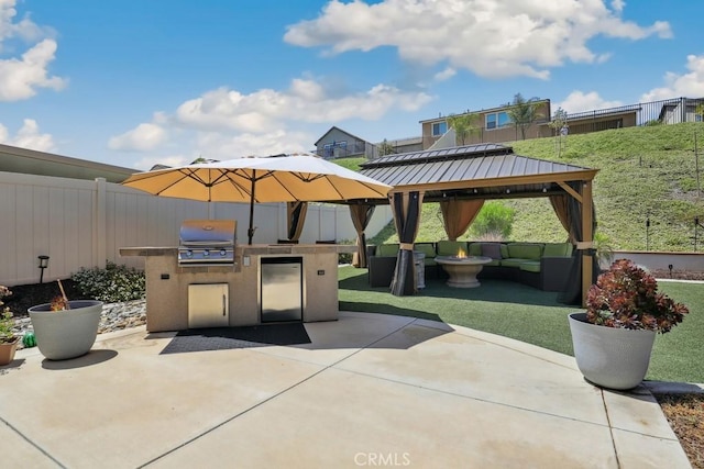 view of patio / terrace with a gazebo, a grill, exterior kitchen, and fence