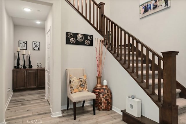 stairs featuring baseboards and wood finished floors