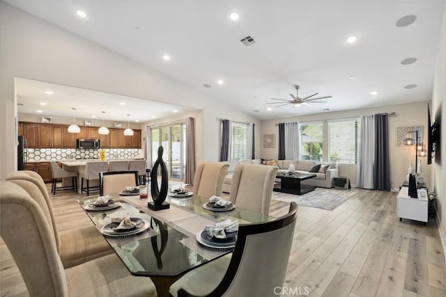 dining area with a ceiling fan, visible vents, recessed lighting, vaulted ceiling, and light wood-type flooring