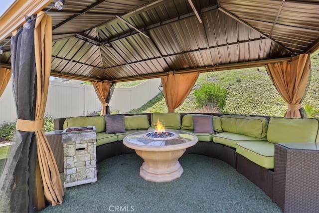 view of patio featuring a gazebo, an outdoor living space with a fire pit, and fence