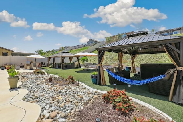 exterior space featuring a gazebo, fence, and a patio area