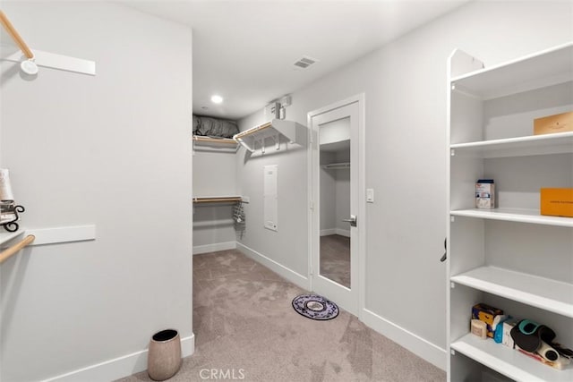 spacious closet with carpet flooring and visible vents