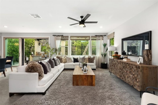 living room with a ceiling fan, recessed lighting, and visible vents