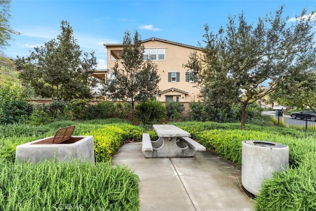 surrounding community featuring a patio and fence