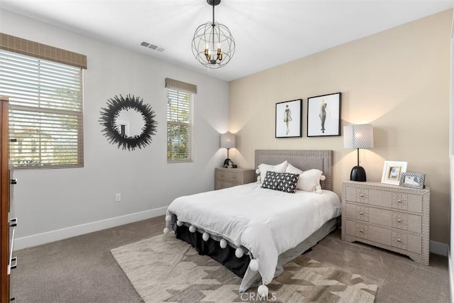 bedroom with carpet floors, visible vents, baseboards, and an inviting chandelier