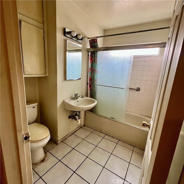 full bath with shower / bath combination, tile patterned flooring, a sink, and toilet