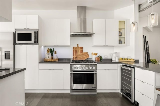 kitchen featuring stainless steel gas stove, dark countertops, wine cooler, wall chimney exhaust hood, and built in microwave