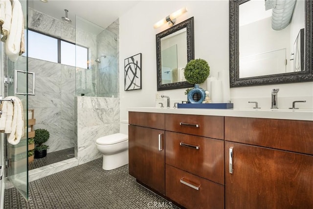 full bath featuring tile patterned flooring, a shower stall, toilet, double vanity, and a sink