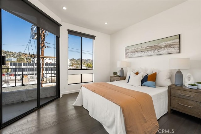 bedroom featuring recessed lighting, baseboards, dark wood-type flooring, and access to exterior