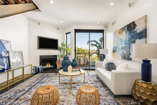 660 N Sweetzer Ave Unit 302, West Hollywood, CA 90048 - living room with recessed lighting, a warm lit fireplace, and wood finished floors