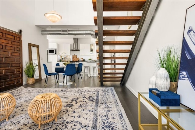 660 N Sweetzer Ave Unit 302, West Hollywood, CA 90048 - dining area with dark wood-style flooring and stairs