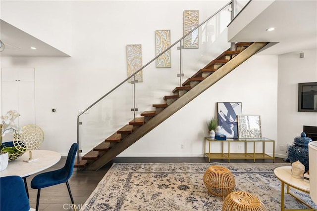 interior space featuring recessed lighting, stairway, baseboards, and wood finished floors