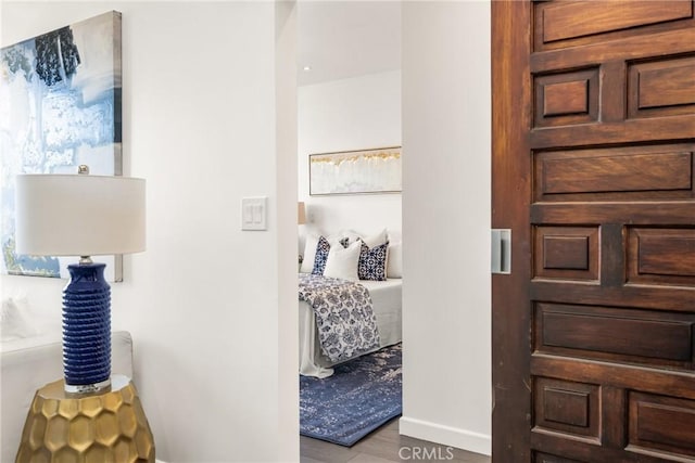 hallway with wood finished floors and baseboards