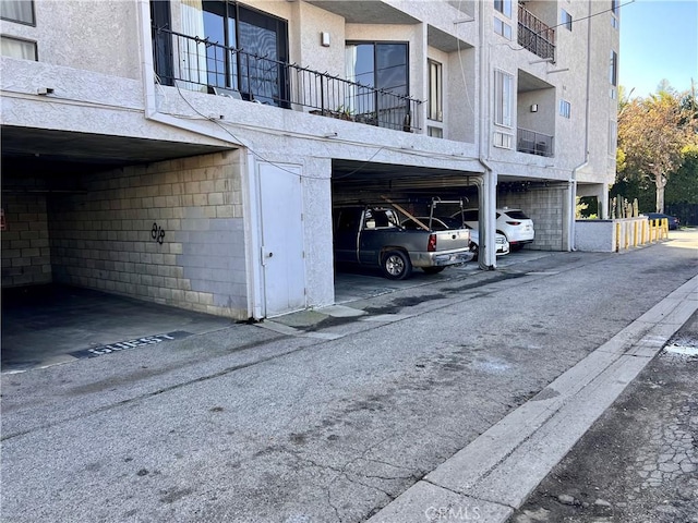 exterior space featuring covered parking