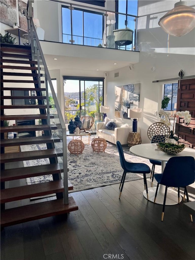 660 N Sweetzer Ave Unit 302, West Hollywood, CA 90048 - dining area with hardwood / wood-style floors, stairs, and a high ceiling
