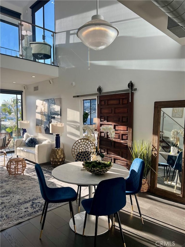 660 N Sweetzer Ave Unit 302, West Hollywood, CA 90048 - dining space with wood finished floors, plenty of natural light, and a towering ceiling