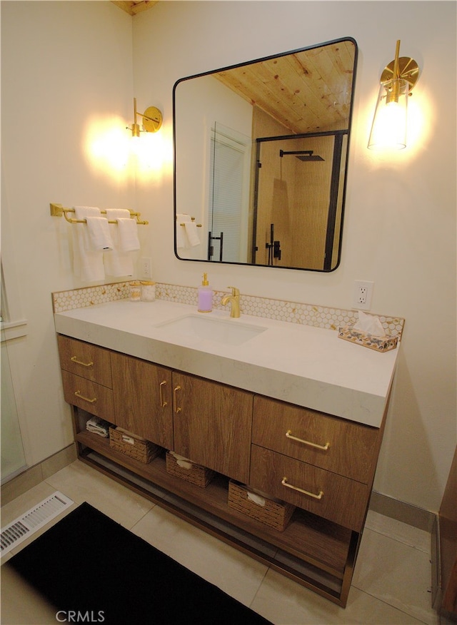 bathroom with visible vents, a shower, vanity, and tile patterned floors