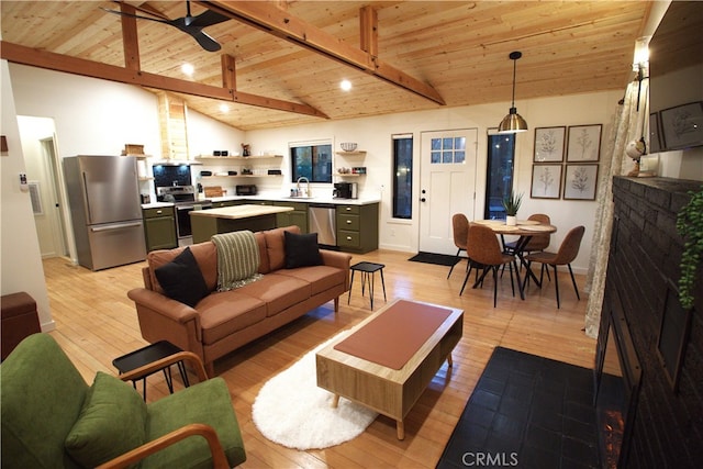 living area featuring beam ceiling, wooden ceiling, and light wood finished floors