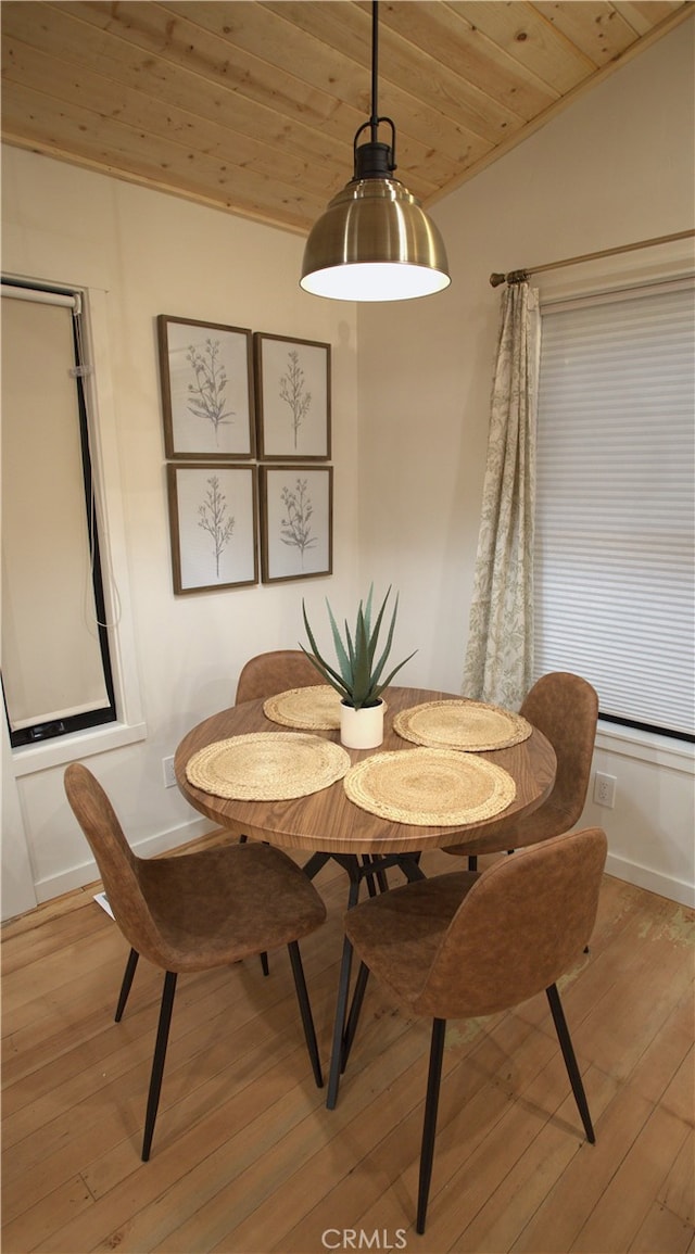 dining area with wooden ceiling, vaulted ceiling, light wood-style flooring, and baseboards