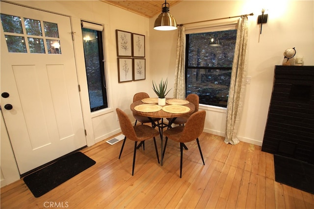 dining area with baseboards, visible vents, and light wood-style floors