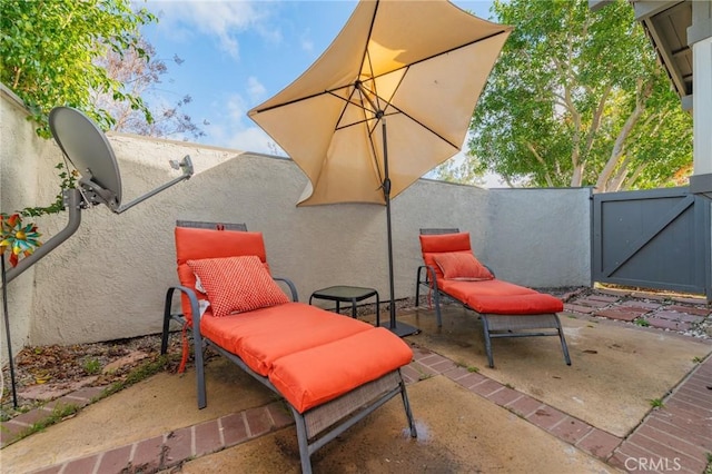 view of patio featuring a gate and fence