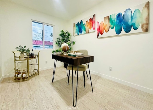 office area featuring baseboards and wood finished floors