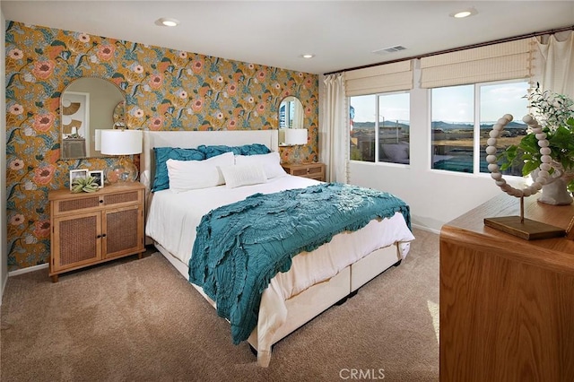 carpeted bedroom featuring baseboards, recessed lighting, visible vents, and wallpapered walls