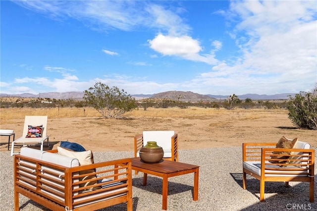 view of yard with an outdoor hangout area, a patio area, and a mountain view