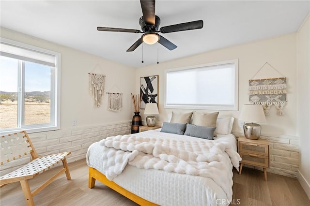 bedroom featuring light wood-style floors and a ceiling fan