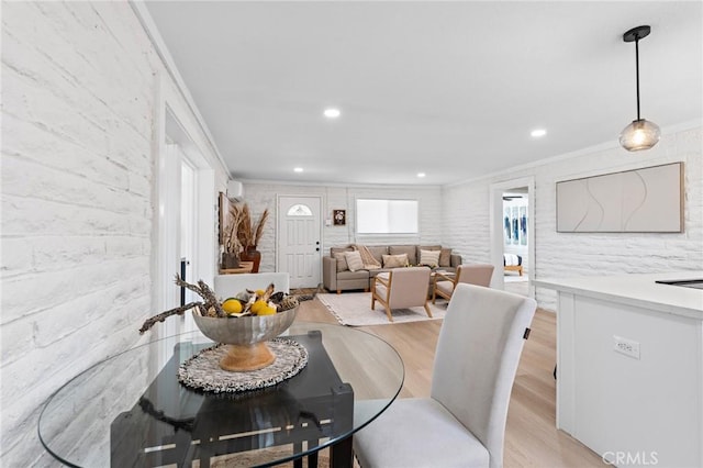 dining room featuring light wood-style floors, ornamental molding, and recessed lighting